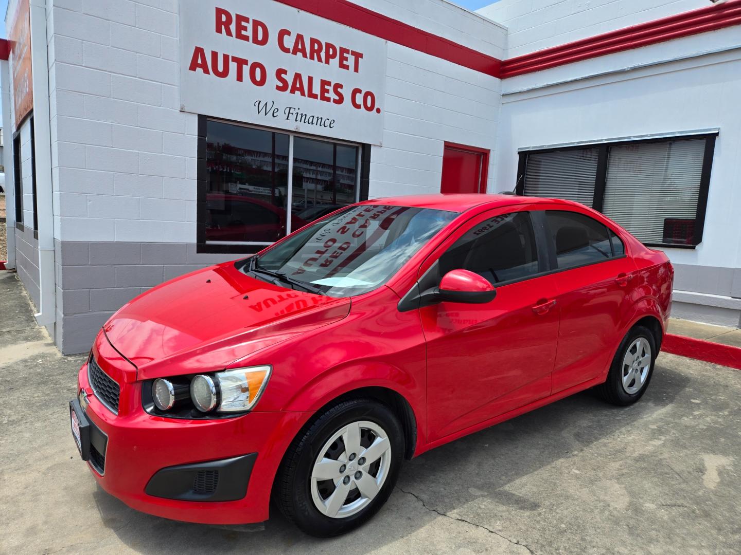 2015 Red /Black Chevrolet Sonic LS Auto Sedan (1G1JA5SH9F4) with an 1.8L L4 DOHC 24V engine, 6-Speed Automatic transmission, located at 503 West Court, Seguin, TX, 78155, (830) 379-3373, 29.568621, -97.969803 - Photo#0